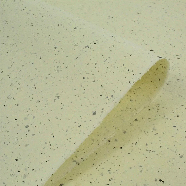 Aesthetic display of Kozo Studio mulberry paper, showcasing fine handmade craftsmanship with soft yellow tones and organic kozo leaf textures.