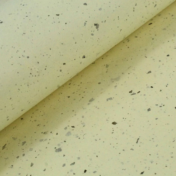 Overlapping Kozo Studio mulberry paper sheets, capturing the speckled detail and subtle translucency of handmade paper infused with kozo fibers.