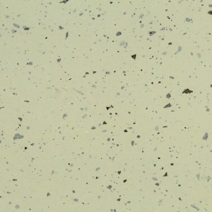 Eco-friendly handmade paper from Kozo Studio, highlighting the unique confetti pattern of crushed kozo leaves on lightweight and creamy mulberry paper.