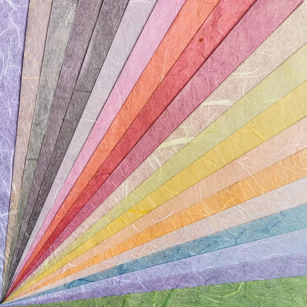 The Assorted A4 Pastel Unryu Kozo Paper Set from Kozo Studio features 40 textured mulberry sheets in vibrant colors like purple, blue, green, yellow, orange, red, and pink.