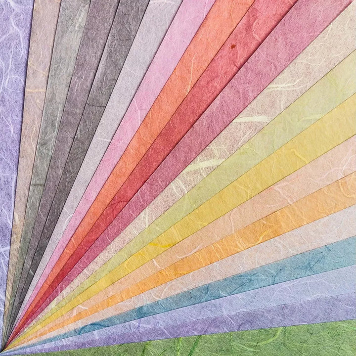The Assorted A4 Pastel Unryu Kozo Paper Set from Kozo Studio features 40 textured mulberry sheets in vibrant colors like purple, blue, green, yellow, orange, red, and pink.