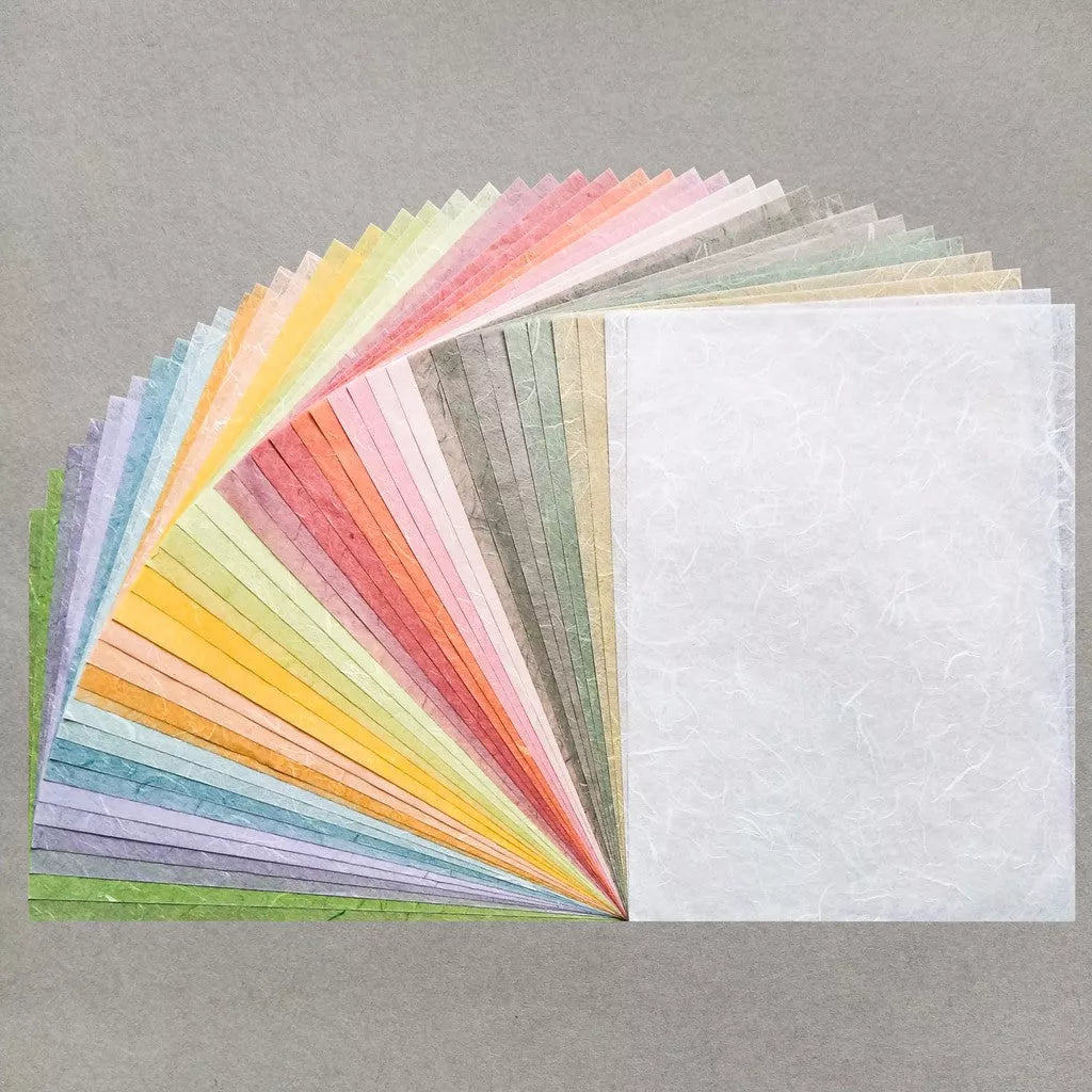 Displayed on a gray background is the Assorted A4 Pastel Unryu Kozo Paper Set by Kozo Studio, featuring vibrant pink, orange, yellow, green, blue, and purple mulberry papers arranged in a fan shape.