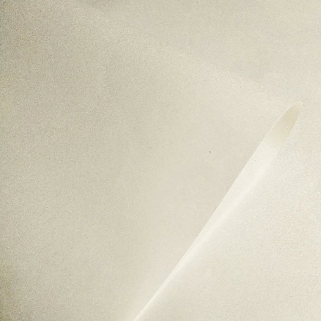 Close-up of Thin Natural Kozo Paper by Kozo Studio, featuring semi-translucent handmade mulberry paper with a smooth off-white texture, ideal for printmaking and calligraphy.