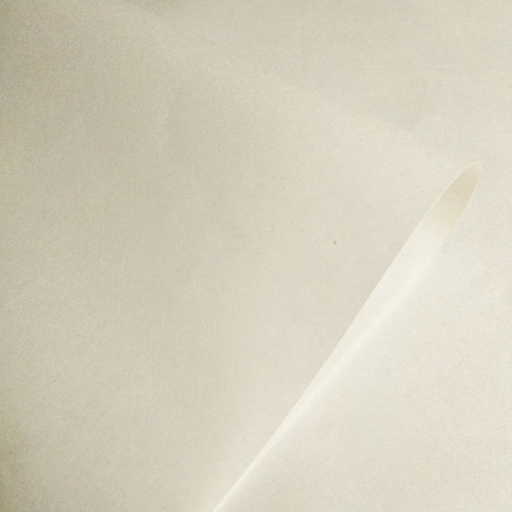 Close-up of Thin Natural Kozo Paper by Kozo Studio, featuring semi-translucent handmade mulberry paper with a smooth off-white texture, ideal for printmaking and calligraphy.