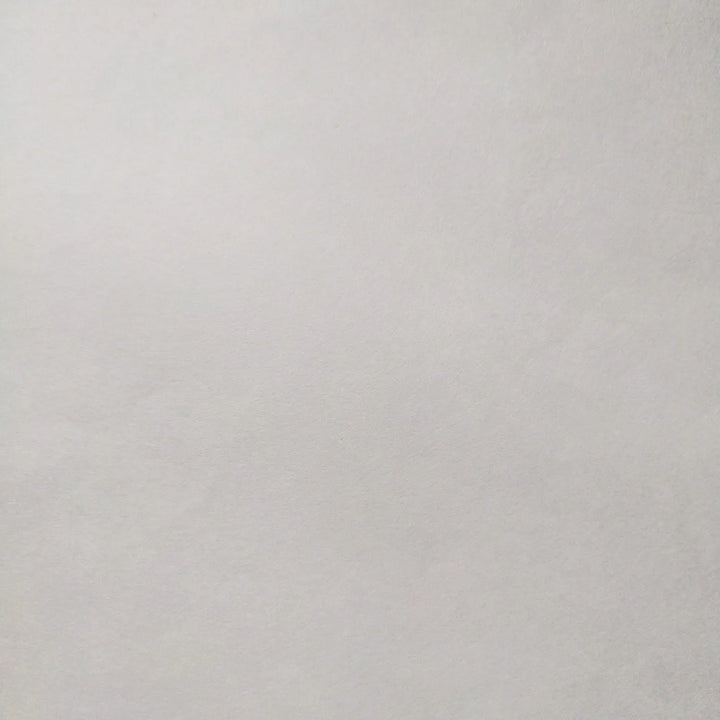 A close-up image of the Thin White Kozo Paper Roll (45 gsm) by Kozo Studio, showing its plain white textured surface with no visible markings or patterns.
