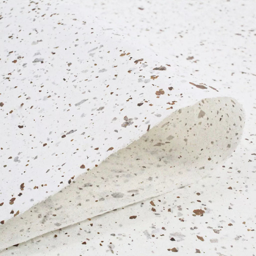 Natural handmade mulberry paper with rough texture and brown-gray flecks, designed by Kozo Studio using Nicotiana leaf elements for a decorative touch.