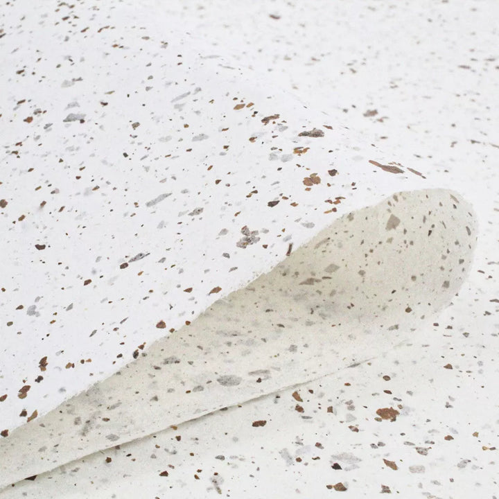 Natural handmade mulberry paper with rough texture and brown-gray flecks, designed by Kozo Studio using Nicotiana leaf elements for a decorative touch.