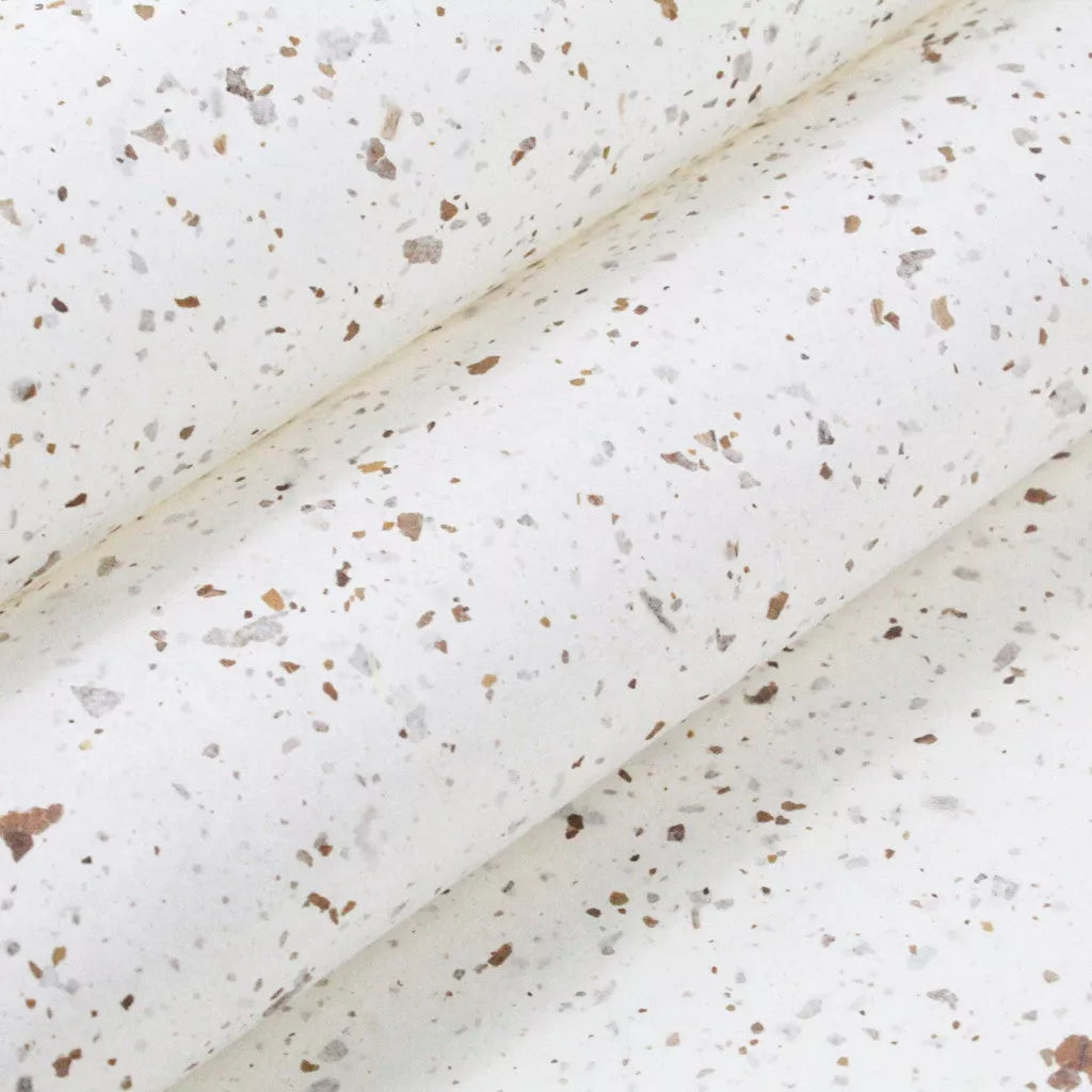Speckled handmade mulberry paper with Nicotiana leaf accents from Kozo Studio, showcasing a semi-translucent yet durable texture perfect for decorative projects.