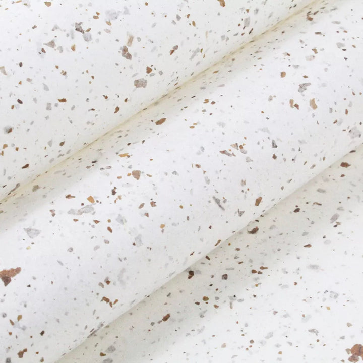 Speckled handmade mulberry paper with Nicotiana leaf accents from Kozo Studio, showcasing a semi-translucent yet durable texture perfect for decorative projects.