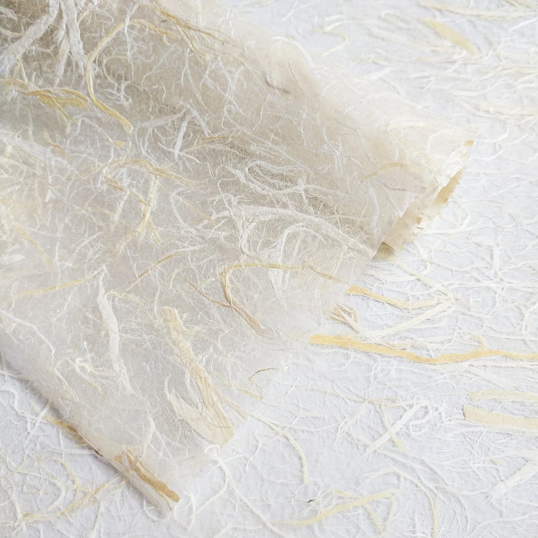 Light and semi-transparent mulberry paper made by Kozo Studio with visible natural fibers, perfect for lampshades and mixed media artwork.