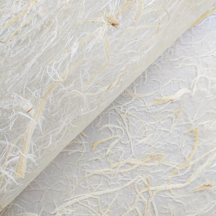 A fine sheet of semi-transparent handmade paper from Kozo Studio, showcasing embedded mulberry bark fibers for use in decorative and functional crafts.