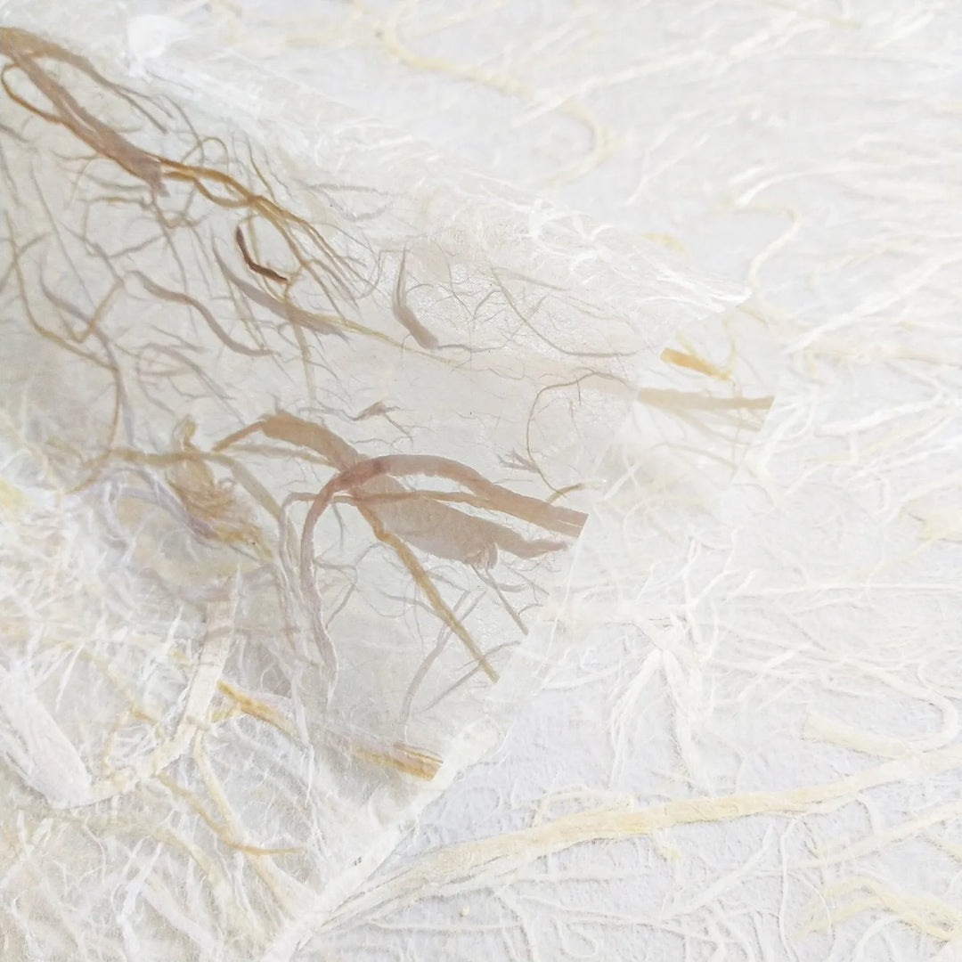 Handmade paper crafted at Kozo Studio featuring an airy composition of mulberry fibers throughout a soft kozo base, ideal for creative projects.