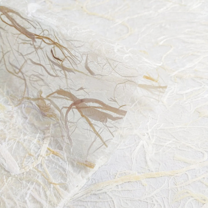 Handmade paper crafted at Kozo Studio featuring an airy composition of mulberry fibers throughout a soft kozo base, ideal for creative projects.