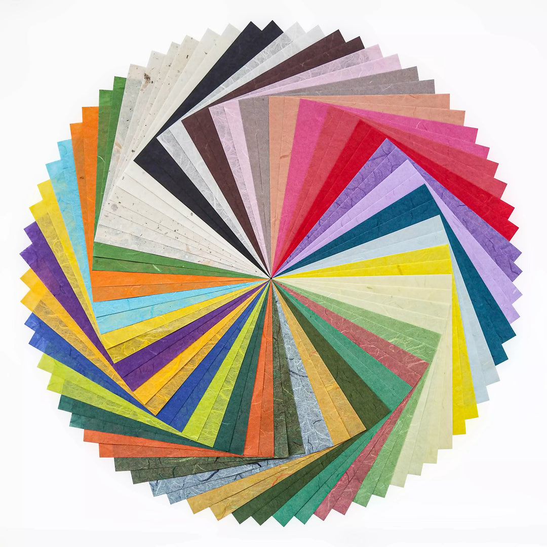 The Origami Unryu Kozo Paper Pack by Kozo Studio features a vibrant, wheel-like design with 72 sheets of colorful, textured mulberry paper in shades of red, blue, green, yellow, and more. Each 6x6 inch sheets edge forms a neat gradient arranged in a circular pattern.