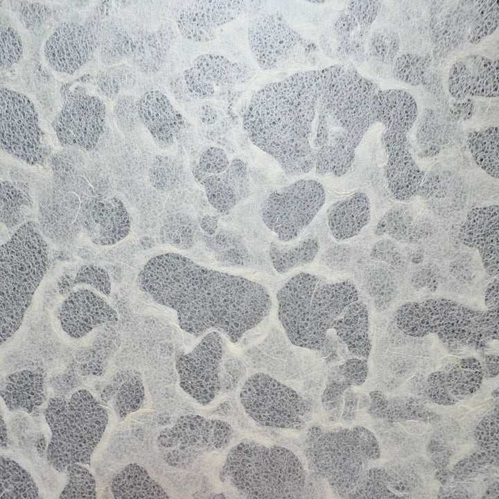 Tidal Lace Kozo Paper (Unryu) by Kozo Studio features a gray and white textured surface with irregular patches and wispy fibers, resembling abstract shapes and evoking the marbled look of eco-conscious handmade mulberry paper.