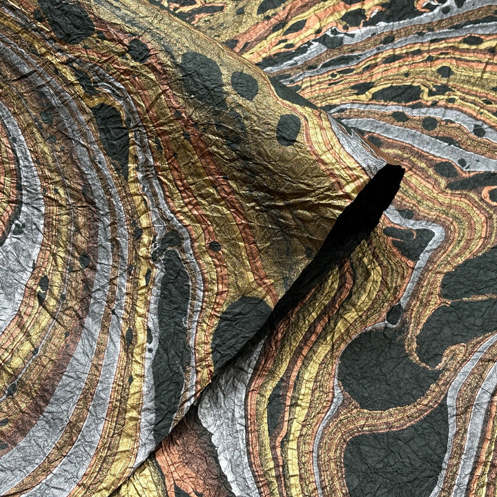 Milano Kozo Paper – Design 9 (Green) embodies artisanal beauty with its graceful marbled design. Handmade by delicately layering mulberry paper over swirling oil-based colors, each sheet boasts a distinct, one-of-a-kind pattern and a soft, fabric-like crinkled texture. Its sophisticated look and exceptional quality make it ideal for creative projects, detailed crafts, or as a striking decorative statement on its own.
