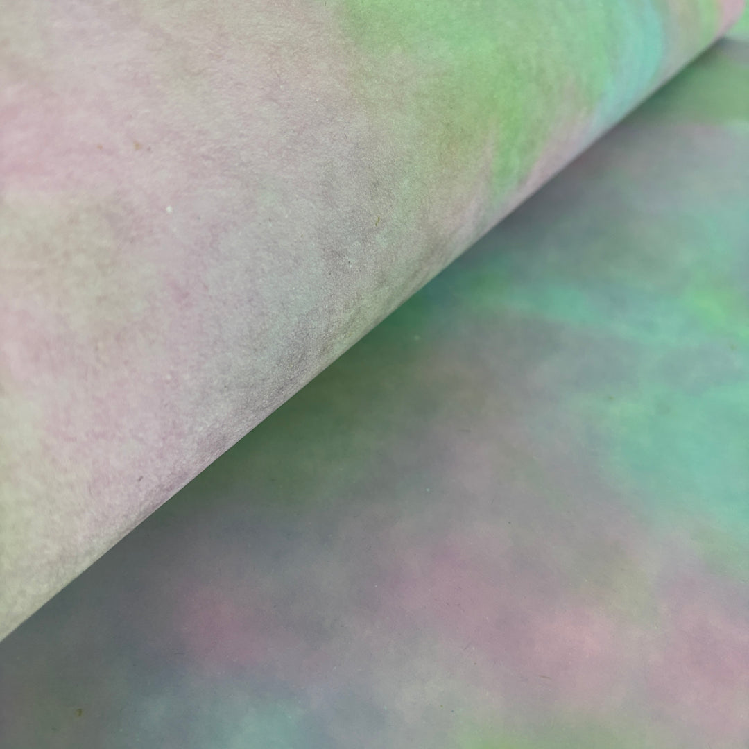 Textured artisan mulberry paper with a dreamy pink-heavy ombre wash for wedding invitations.