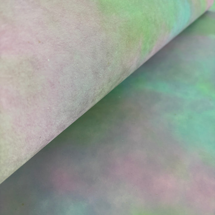 Textured artisan mulberry paper with a dreamy pink-heavy ombre wash for wedding invitations.