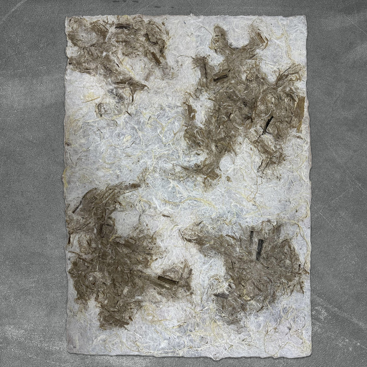 Artistic handmade paper by Kozo Studio featuring rugged mulberry texture and an organic color blend ideal for collage, lampshades, and mixed media.