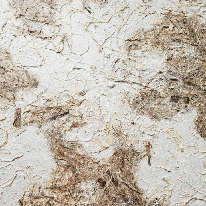 A close-up of the Handmade Earthy Harmony Kozo Paper by Kozo Studio showcases an abstract, fibrous pattern on mulberry paper, blending beige and brown tones with intertwined fibers on a light beige background for an organic, natural look.
