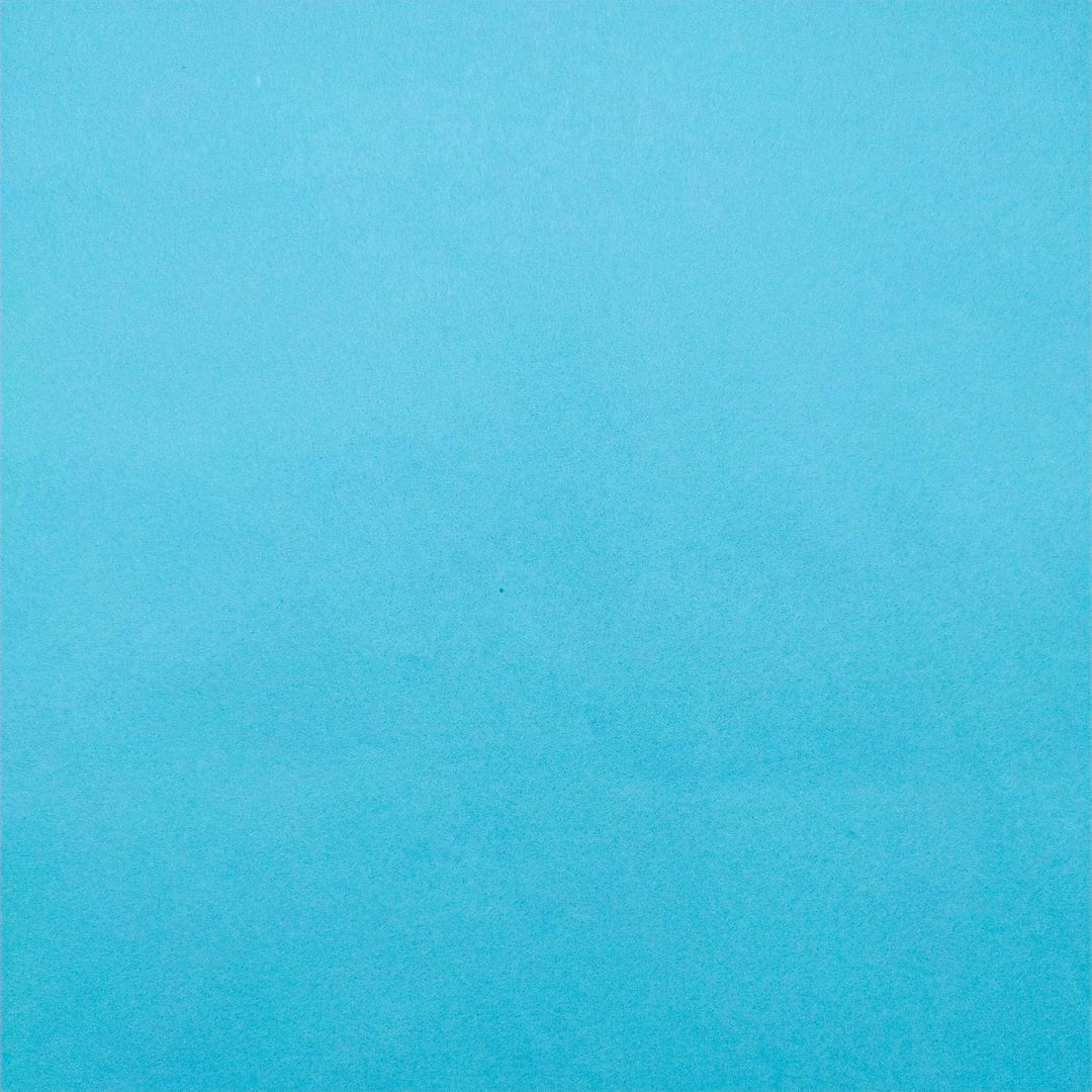 Kozo Studio paper in Atoll Blue captured in detail with gentle curling and fine mulberry paper fiber.