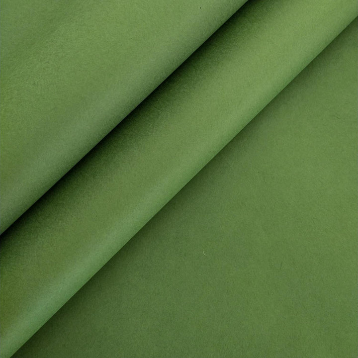 Close-up of fern green handmade paper from Kozo Studio with smooth texture mulberry paper, featuring gentle folds that create soft shadows and highlights.