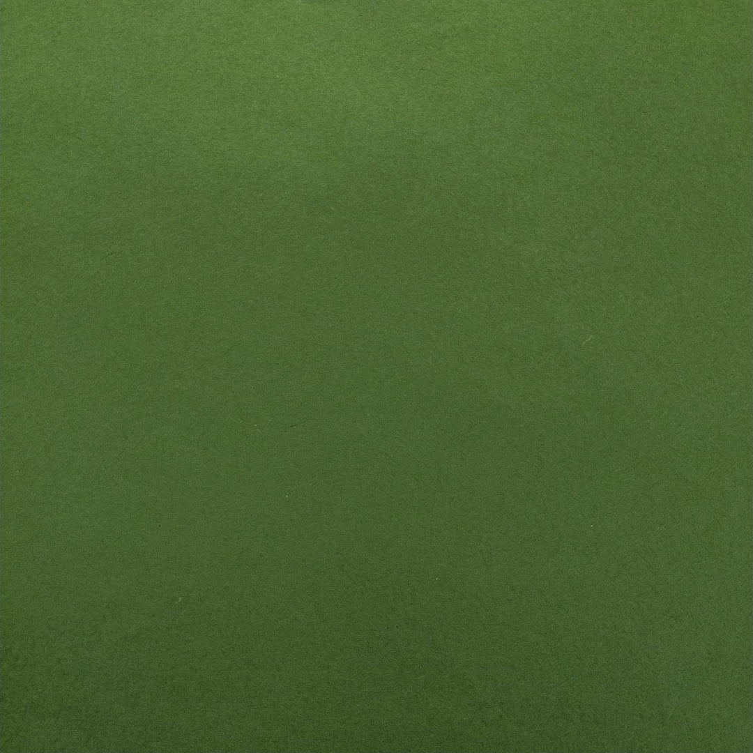 Detailed photo of Kozo Studio handmade mulberry paper in a rich fern green shade, with delicate folds adding depth and subtle contrast.