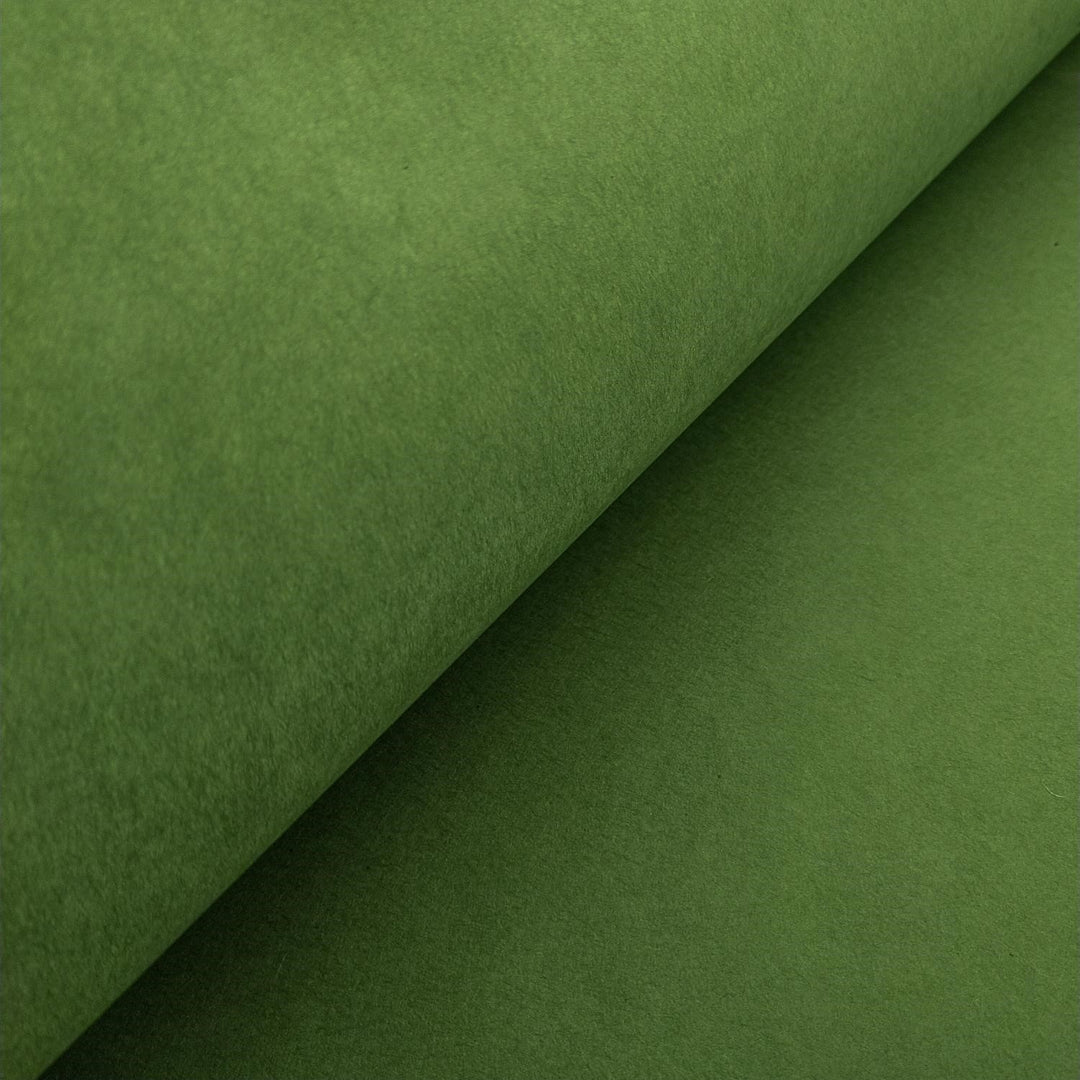 High-resolution image of solid-colored mulberry paper from Kozo Studio, showing the soft folds and smooth handmade texture in fern green.