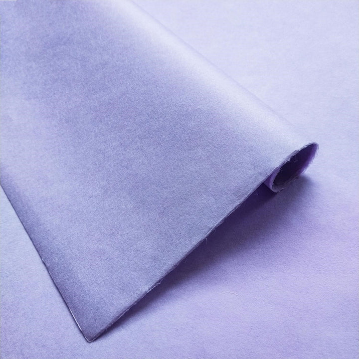 A detailed view of Kozo Studio solid-colored handmade paper in heather purple, showing the fine texture and durable mulberry paper fibers.
