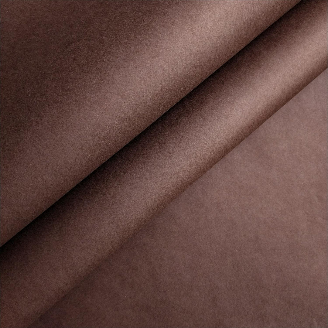 Close-up of tawny brown mulberry paper with smooth texture and gentle folds handcrafted by Kozo Studio.