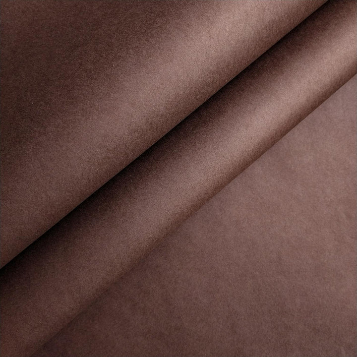 Close-up of tawny brown mulberry paper with smooth texture and gentle folds handcrafted by Kozo Studio.