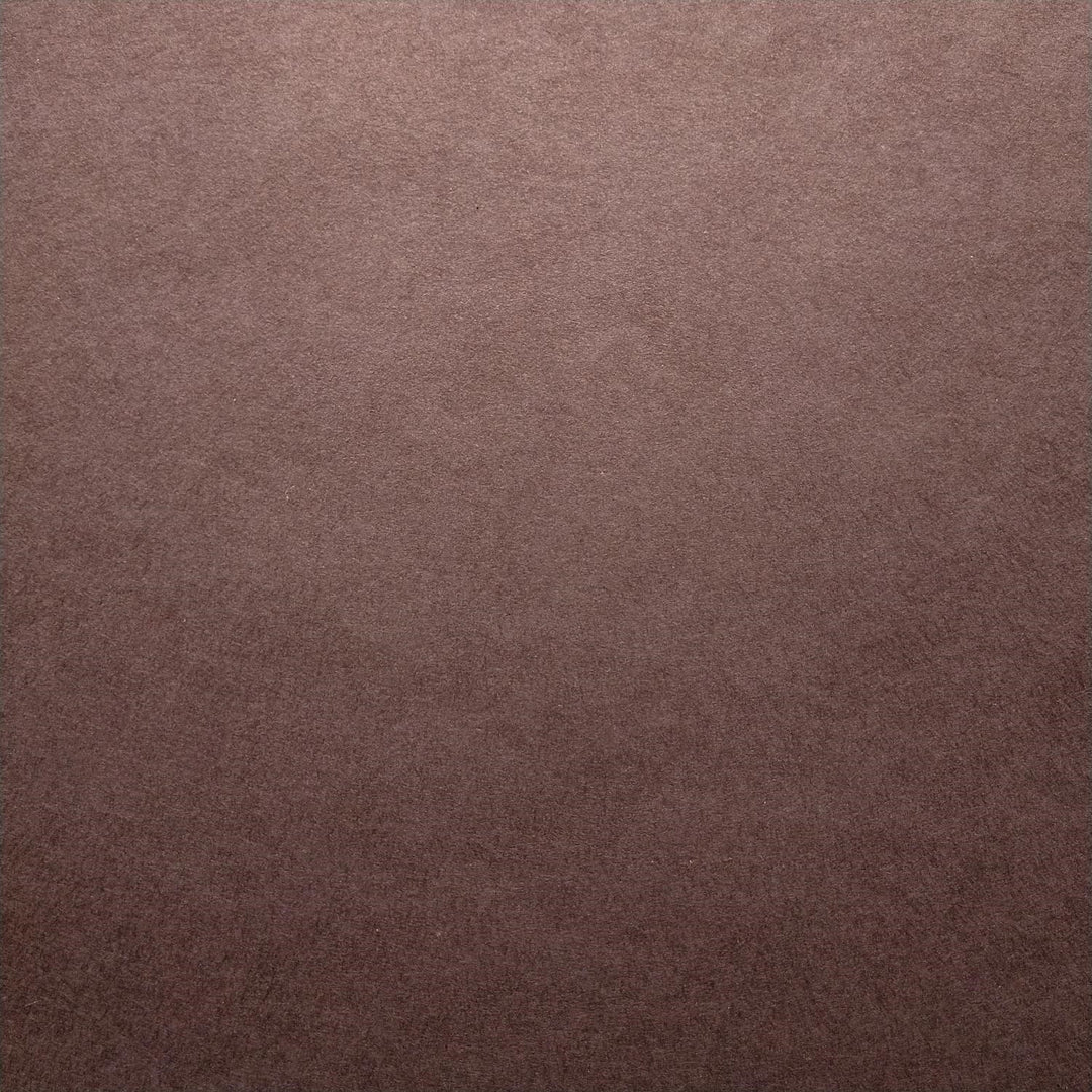 Solid-colored Kozo Studio mulberry paper in tawny brown with soft lighting that highlights its texture and craftsmanship.