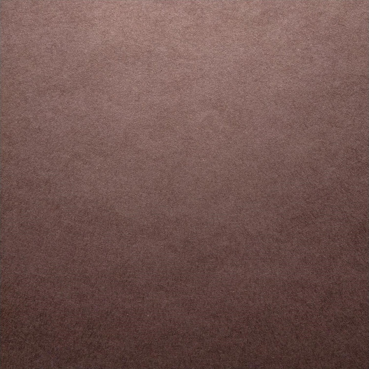Solid-colored Kozo Studio mulberry paper in tawny brown with soft lighting that highlights its texture and craftsmanship.
